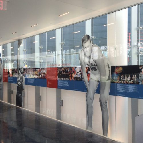 Inside Kansas University, a view of the glass mural depicting images and copy from the history of basketball.