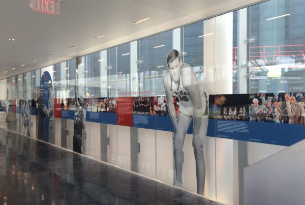 Inside Kansas University, a view of the glass mural depicting images and copy from the history of basketball.