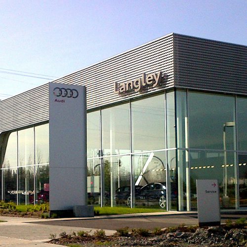 Exterior shot of Audi dealership featuring oversized, insulated glass units combining low-e and clear glass.