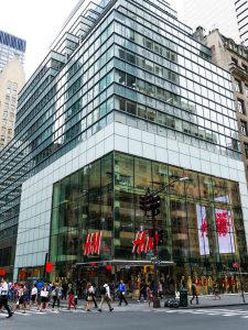 Across the street, corner view of H&M flagship store on 5th ave. Highlights the oversize laminated and insulated glass units.