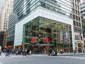 Across the street, corner view of H&M flagship store on 5th ave. Highlights the oversize laminated and insulated glass units.