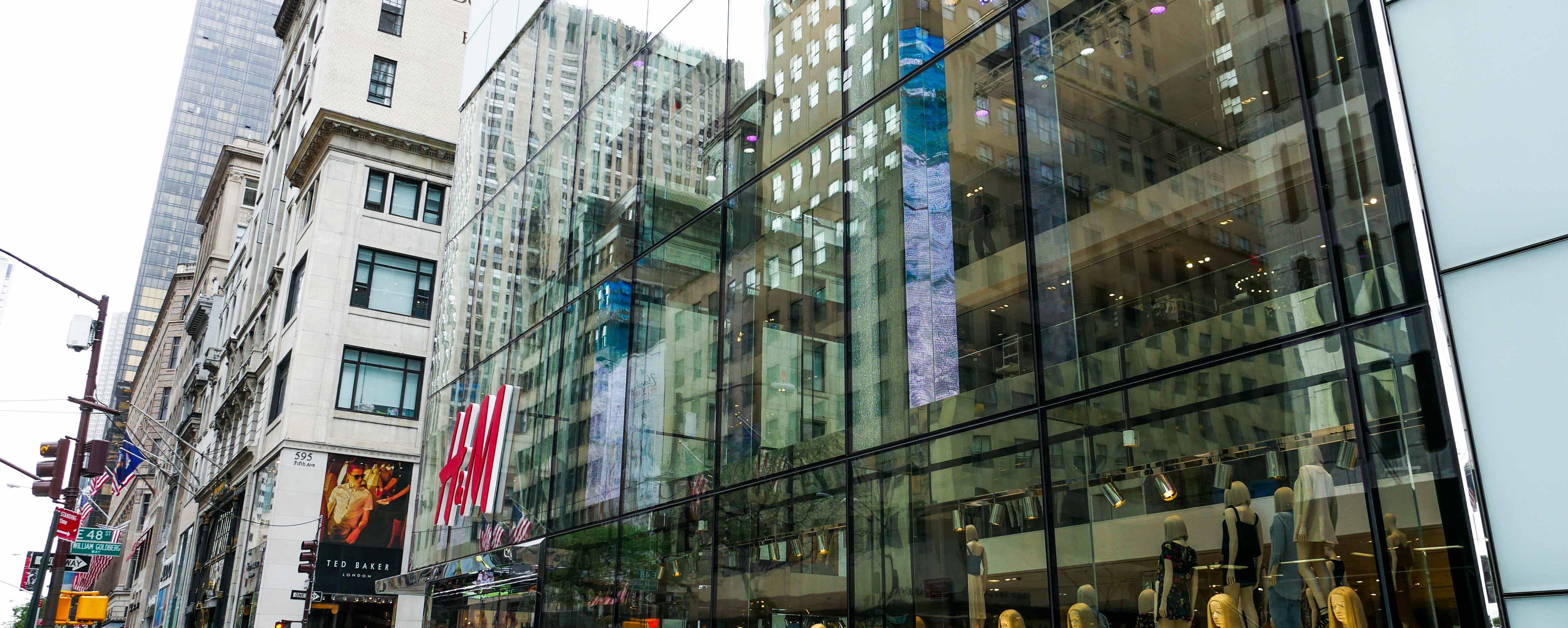 Sideview of view of H&M flagship store on 5th ave. Highlights the oversize laminated and insulated glass units.