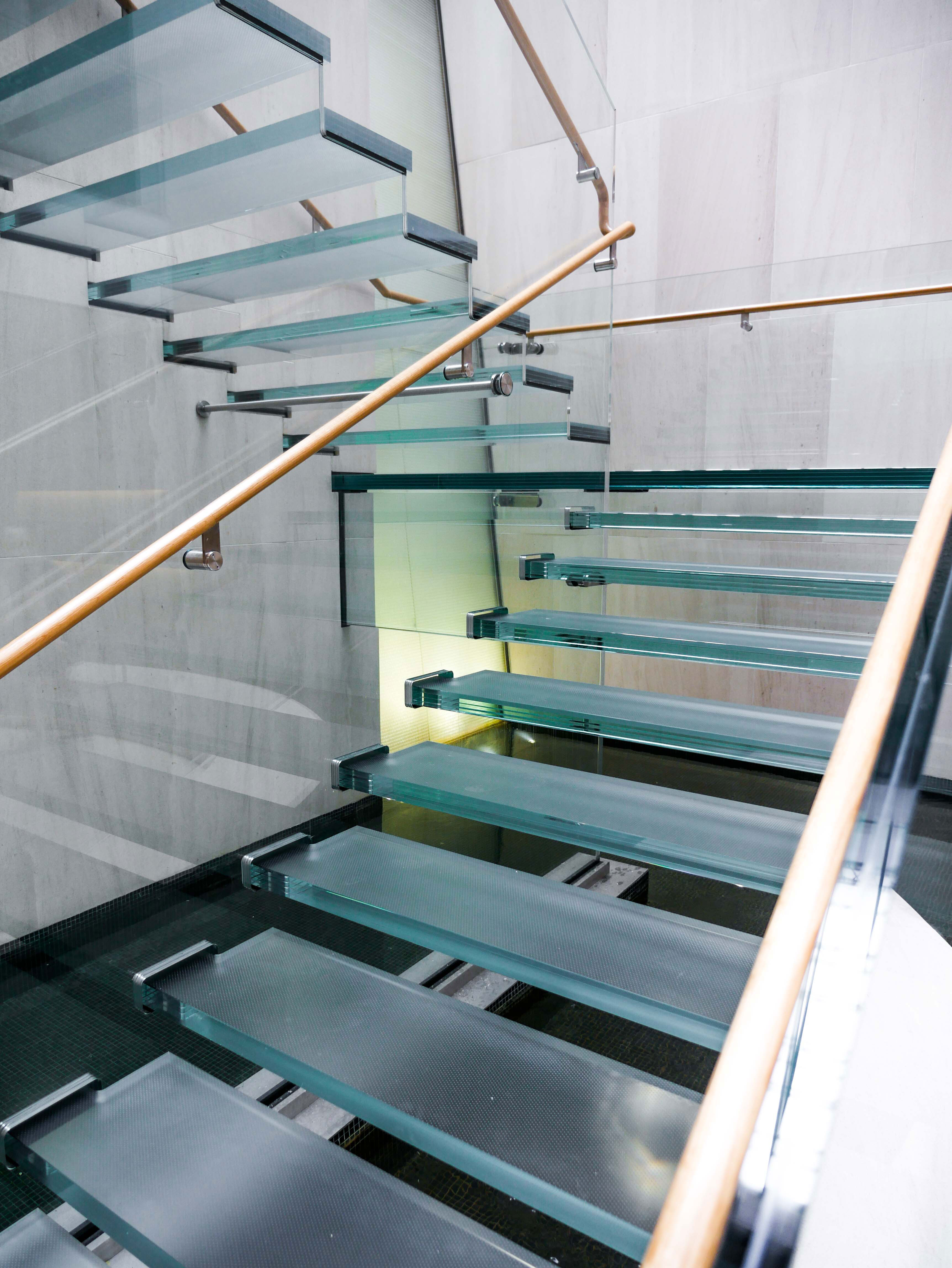 View of staircase, close up on treads and handrail.