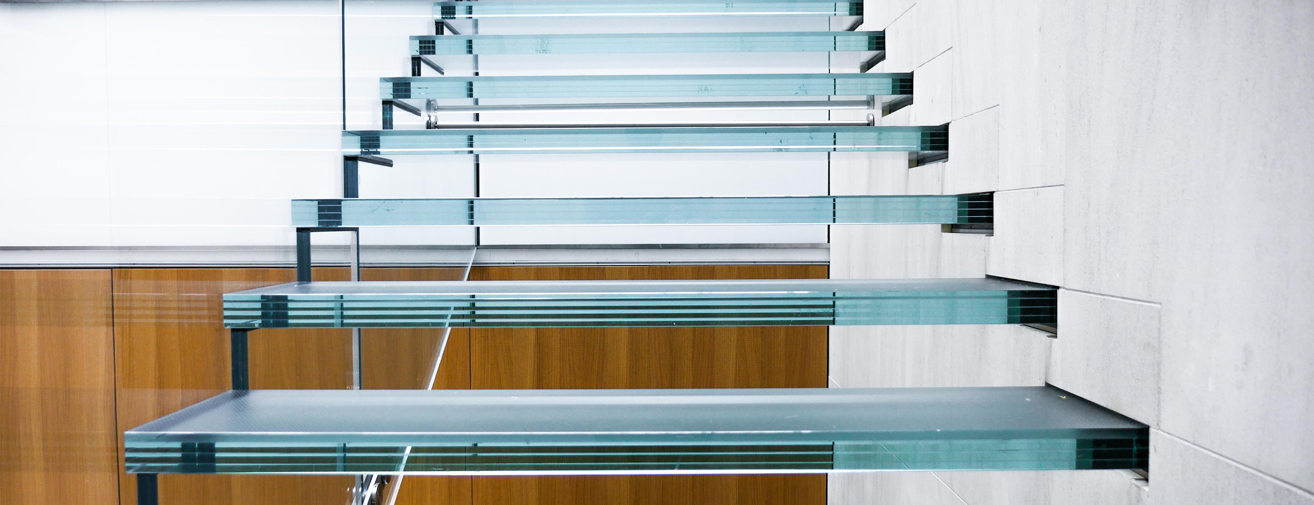 View of staircase, close up on treads and handrail.