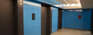 Blue elevator featuring Low-iron, roller-coated back-painted glass for The Bow in Calgary.