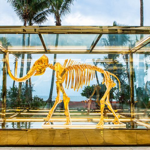 Gilded woolly mammoth encased in oversize insulated glass units