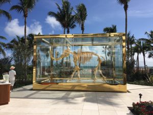 "Gilded woolly mammoth encased in glass vitrine"