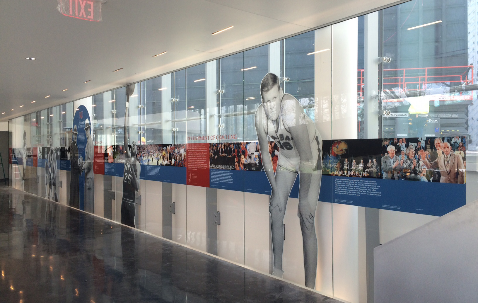 Inside Kansas University, a view of the glass mural depicting images and copy from the history of basketball.