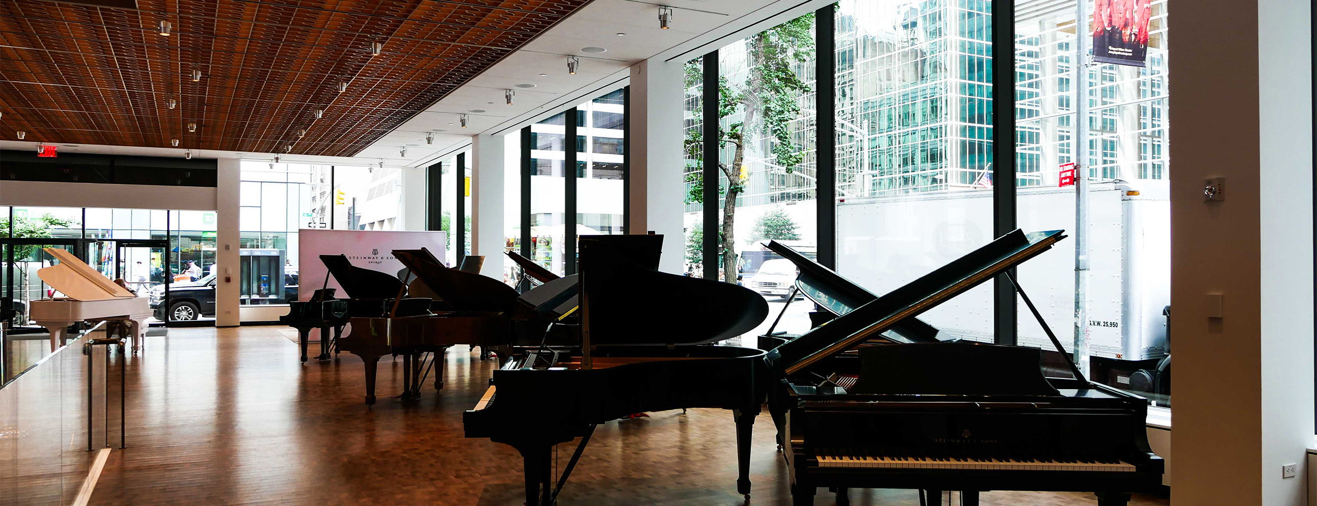 Inside Steinway & Sons looking at grand pianos and insulated glass units consisting of low-iron and low-e glass