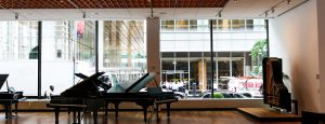 Inside Steinway & Sons looking at grand pianos and insulated glass units consisting of low-iron and low-e glass