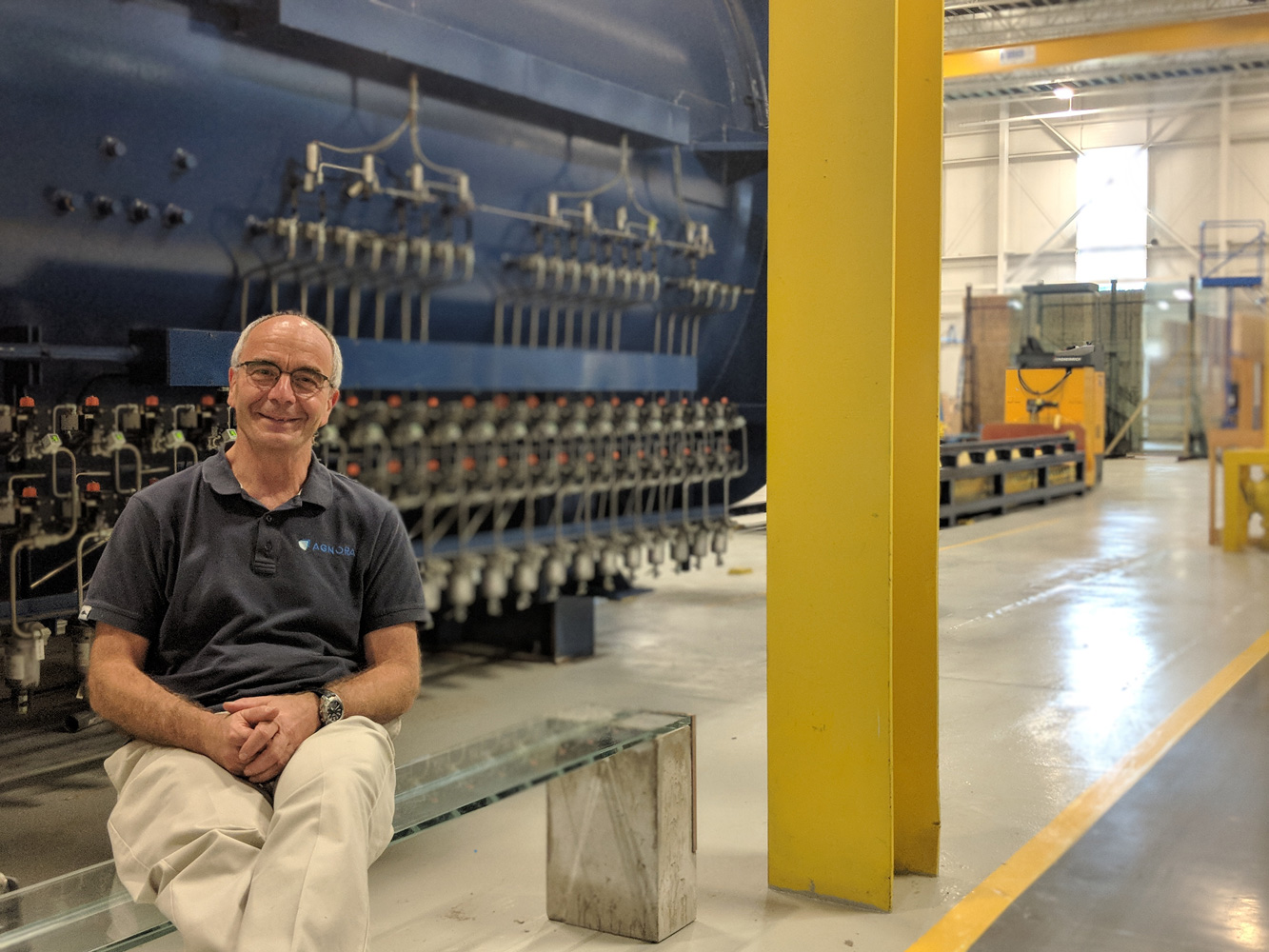 Louis Moreau sits on his own glass bench that he made in the AGNORA plant, out of remnant glass from their MOMA project.