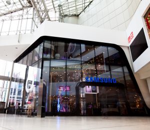 Interior mall view of all-glass façade for Samsung consists of oversized/jumbo, insulated, Low-E, glass units with complex, compound curves fabricated by AGNORA